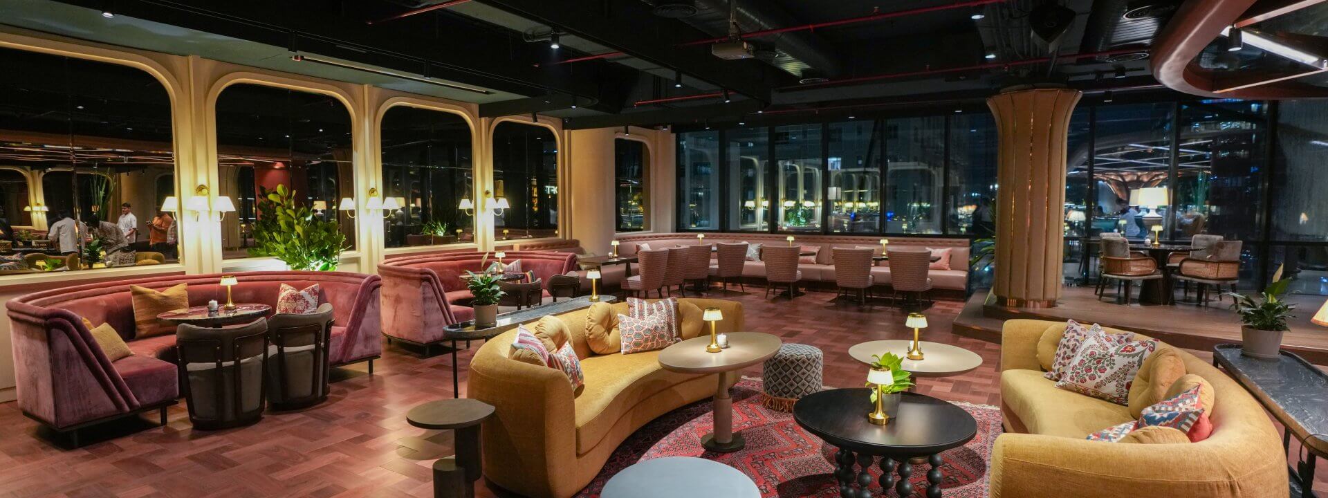 Luxurious bar area at The Quorum Club Mumbai with elegant seating and ambient lighting