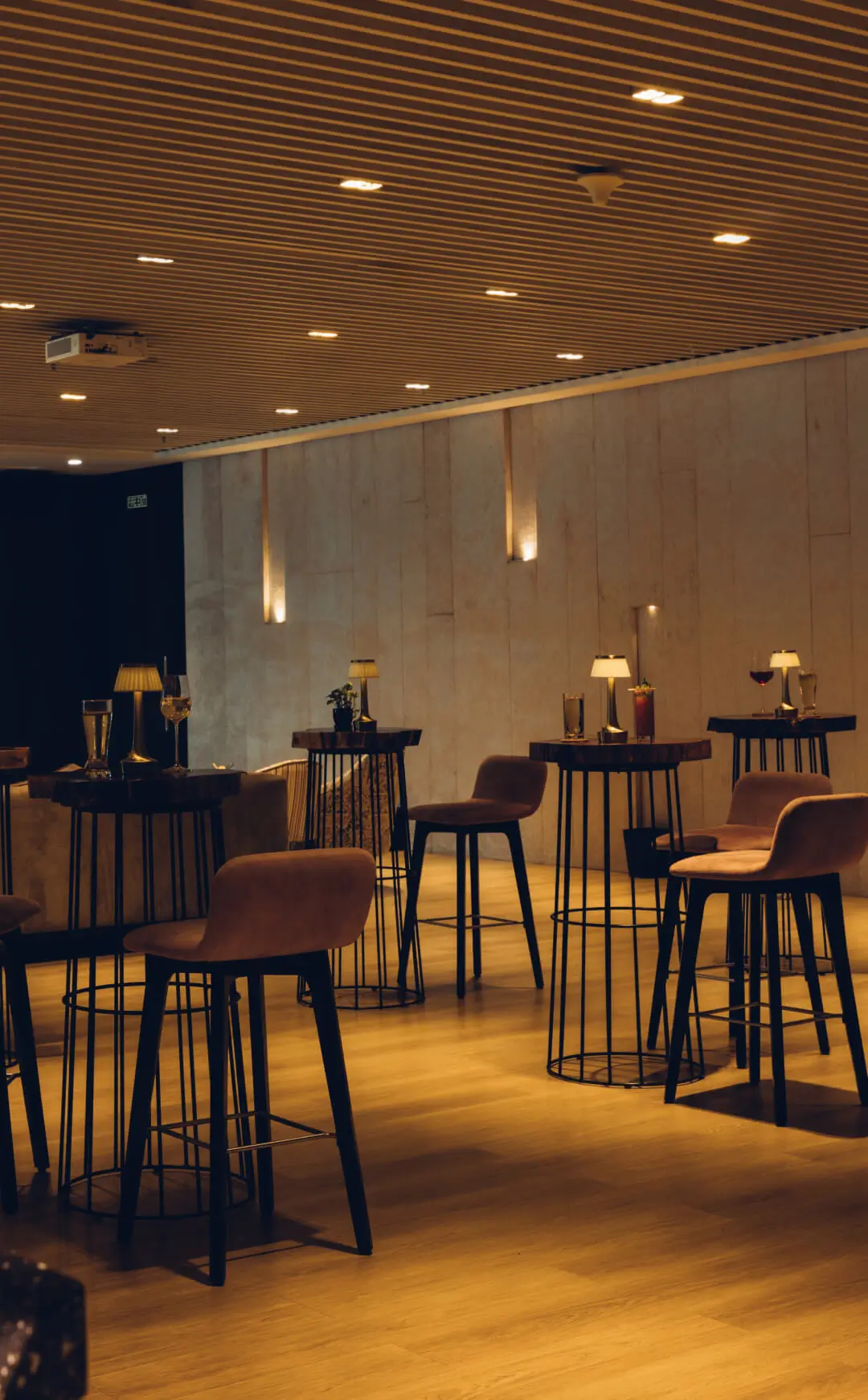 Members enjoying panoramic city views in intimate spaces at The Quorum, Mumbai's premier members-only club.